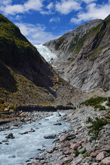 the spectacular franz joseph glacier and waipo river along the franz joseph glacier hike  on a sunny summer day, near the town of franz joseph on the west coast of the south island of new zealand
