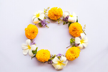 flowers marigold, frangipani, purple flowers arrangement flat lay circle postcard style on...