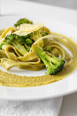 Plate with tasty pasta and vegetables on table, closeup