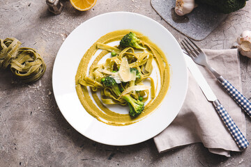 Plate with tasty pasta and vegetables on table