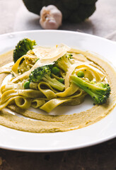 Plate with tasty pasta and vegetables on table, closeup