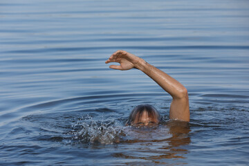 Drowning man reaching for help in sea, closeup