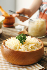 Bowl with tasty sauerkraut on kitchen table