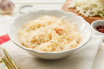 Bowl with tasty sauerkraut on table