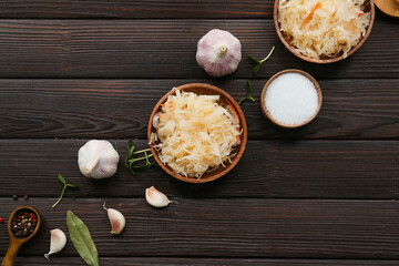 Composition with tasty sauerkraut on wooden background