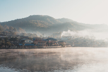Fototapeta na wymiar fog on the river with village background