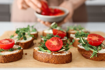 Tasty fresh toasts on table in kitchen, closeup