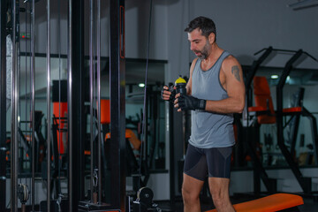 Bodybuilder doing underhand cable tricep pushdowns during his workout in the gym