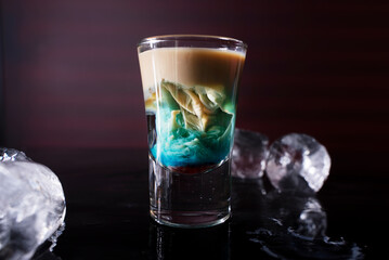 Cocktail shots at the bar counter. Cocktail at the bar. Alcoholic drink at the night club.