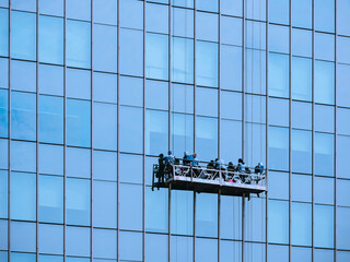 Cleaning Glass window facade Building maintenance Architecture exterior with workers