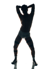 Cheerful young man in trunks over white background