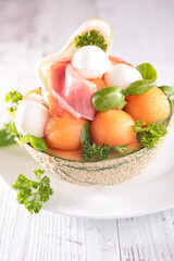 melon salad with prosciutto ham,  mozzarella and basil