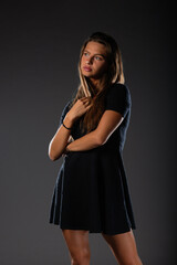 Beautiful elegant women celebrate wearing black stylish evening dress and high heel shoes. Isolated photo.