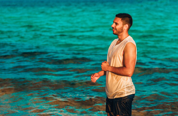 Handsome smiling man enjoying day on the beach