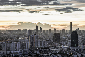 Bangkok, thailand - Jul  02, 2021 : Aerial view of Beautiful sunset over large metropol city in Asia. With tall building and skyscraper in background. Monotone, Selective focus.