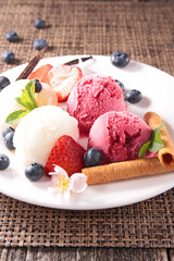 ice cream scoop with biscuit and blueberries