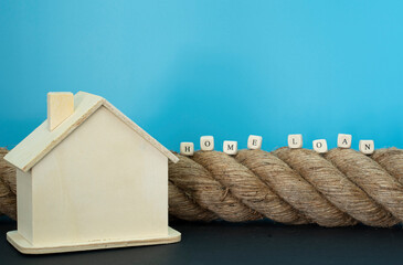 Financial concept. Rope, house model and wooden blocks with text. Selective focus points. - obrazy, fototapety, plakaty