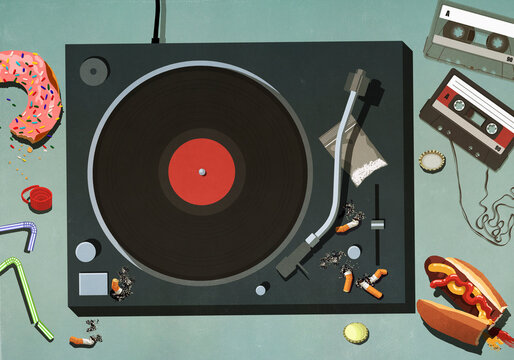 Junk food, cigarettes and cassette tapes around record turntable

