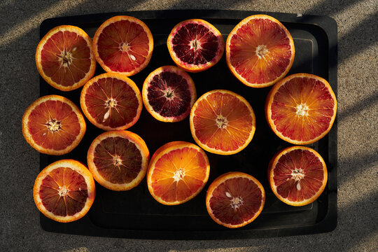 Blood and navel orange cross sections on tray
 - Powered by Adobe