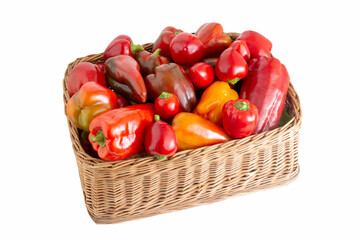 Wicker basket with red bell pepper on a white background, isolate. Healthy food concept, summer natural harvest. Shopping