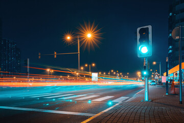 Pedestrian crossing over a busy highway with a traffic light taken at a long shutter speed with...