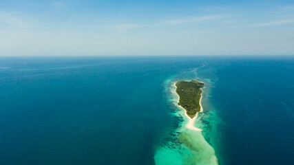 Travel concept: sandy beach on a small island Little Santa Cruz by coral reef atoll from above....