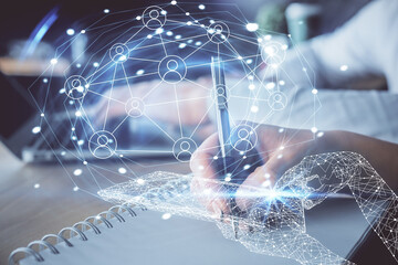 Double exposure of social network theme drawing over people taking notes background. Concept of human connection