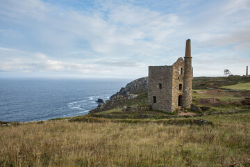 Botallack tin mine ruins in Cornwall seen from the South West Coast footpath with the Atlantic Ocean in the background