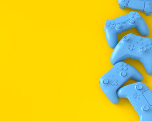 Set of lying gamer joysticks or gamepads on yellow background