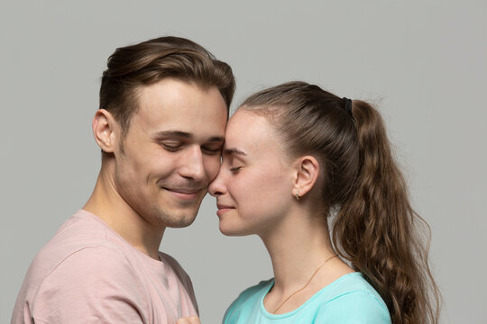 Studio portrait affectionate, tender young couple
