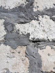 part of an old wall built of stone blocks and firmly bonded with cement