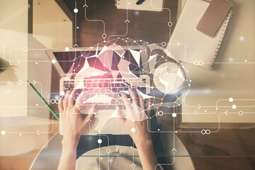 Double exposure of woman working on computer andhuman brain hologram drawing. Top View. Ai concept.