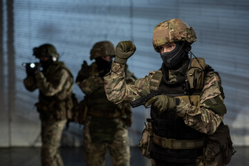 Group of men in camouflage uniform holding guns