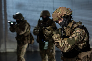 Military men with guns and lanterns coming after criminal