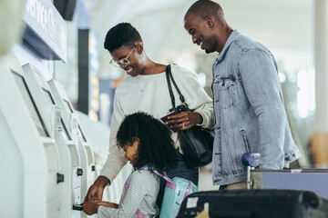 Family check-in using self service machine at airport