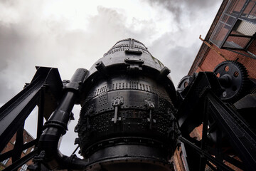 Bessemer converter steel and iron foundry equipment Sheffield bulk metal production. stormy cloud...