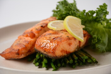 Fried salmon steaks. Cooked salmon steak with pepper, herbs, lemon, garlic, olive oil and Brussels sprouts. Grilled fresh fish.