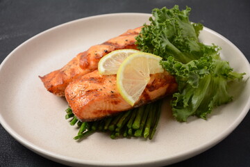 Fried salmon steaks. Cooked salmon steak with pepper, herbs, lemon, garlic, olive oil and Brussels sprouts. Grilled fresh fish.