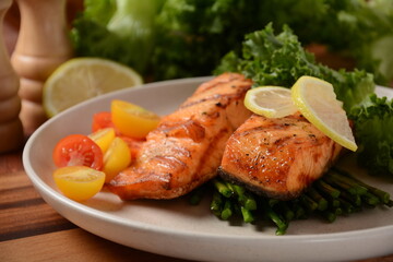 Fried salmon steaks. Cooked salmon steak with pepper, herbs, lemon, garlic, olive oil and Brussels sprouts. Grilled fresh fish.