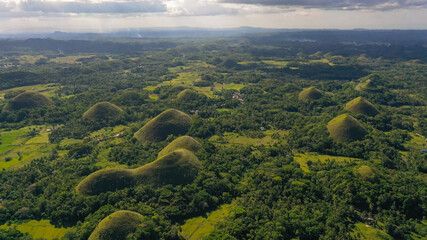 Famous Chocolate Hills natural landmark, Bohol island, Philippines. Hills among farmlands.