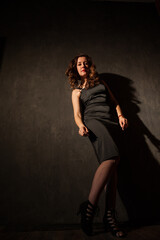 Portrait of a beautiful brunette woman in a black evening dress