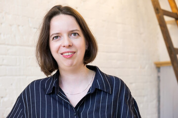 Portrait of a smiling woman with a non-standard appearance