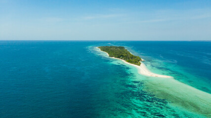 Island with a sandy beach and azure water surrounded by a coral reef and an atoll. Little Santa...