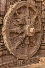 Detail of chariot wheel and religious carvings decorating the ancient Surya Hindu Temple at Konark Orissa India. 13th Century AD