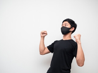 Asian man black shirt with mask double fist up and  look up feel happy on white isolate background