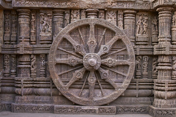 Detail of chariot wheel and religious carvings decorating the ancient Surya Hindu Temple at Konark Orissa India. 13th Century AD