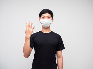 Asian man black shirt with mask show four finger counting on white isoated background