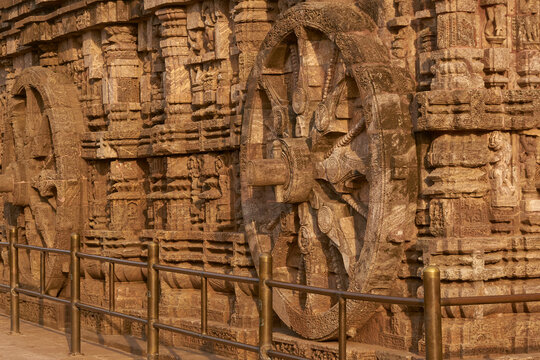Detail of chariot wheel and religious carvings decorating the ancient Surya Hindu Temple at Konark Orissa India. 13th Century AD