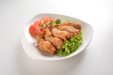 deep fried golden crispy prawn meat ball roll traditional wu Xiang with spicy sauce in white background asian halal snack menu