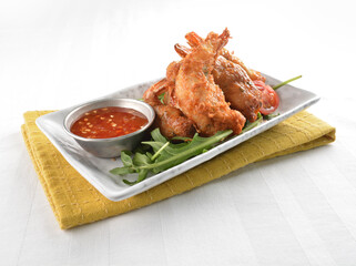 deep fried golden crispy prawn meat ball roll traditional wu Xiang with spicy sauce in white background asian halal snack menu
